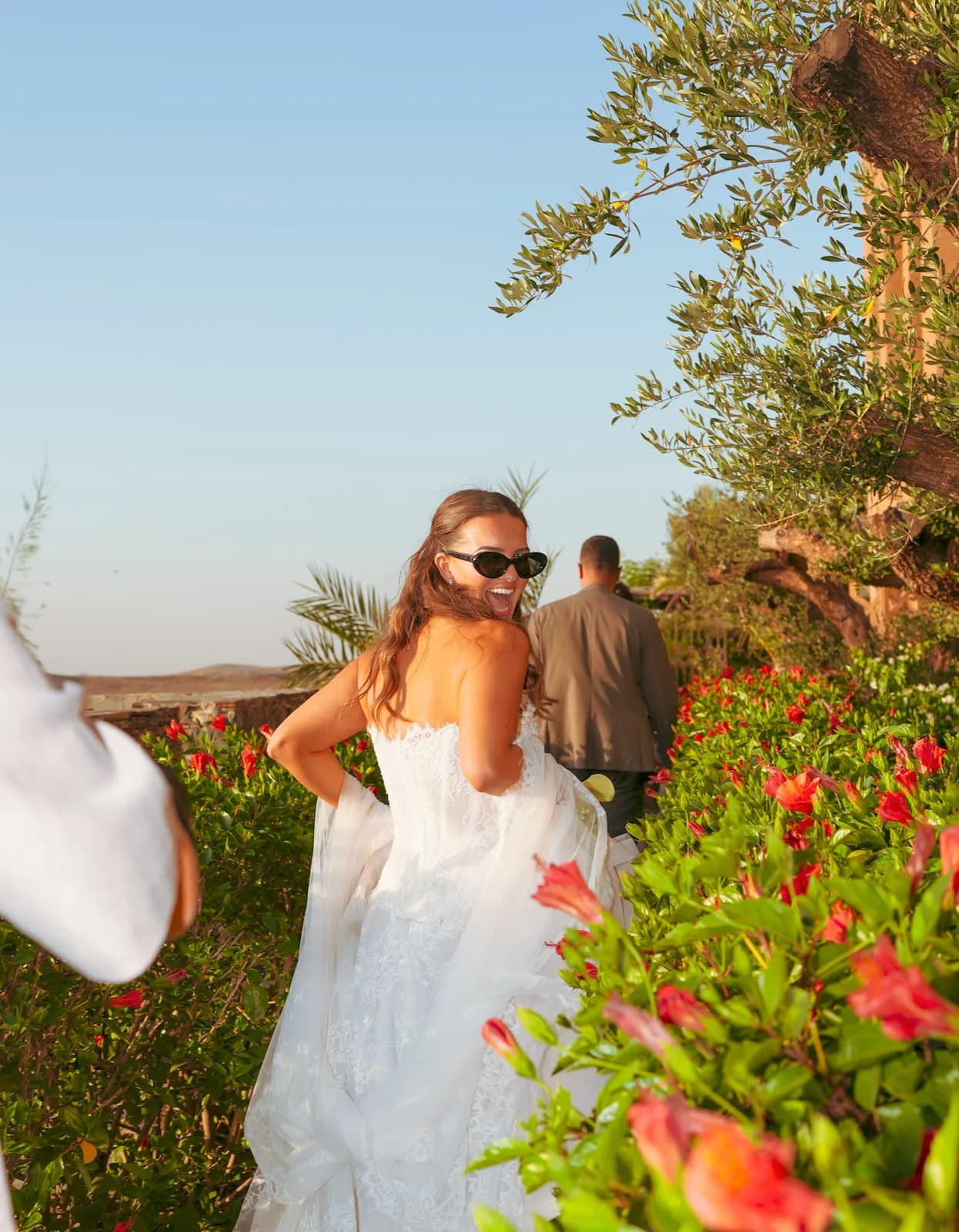 Bride glancing back over her shoulder in the venue gardens, Marrakech destination wedding