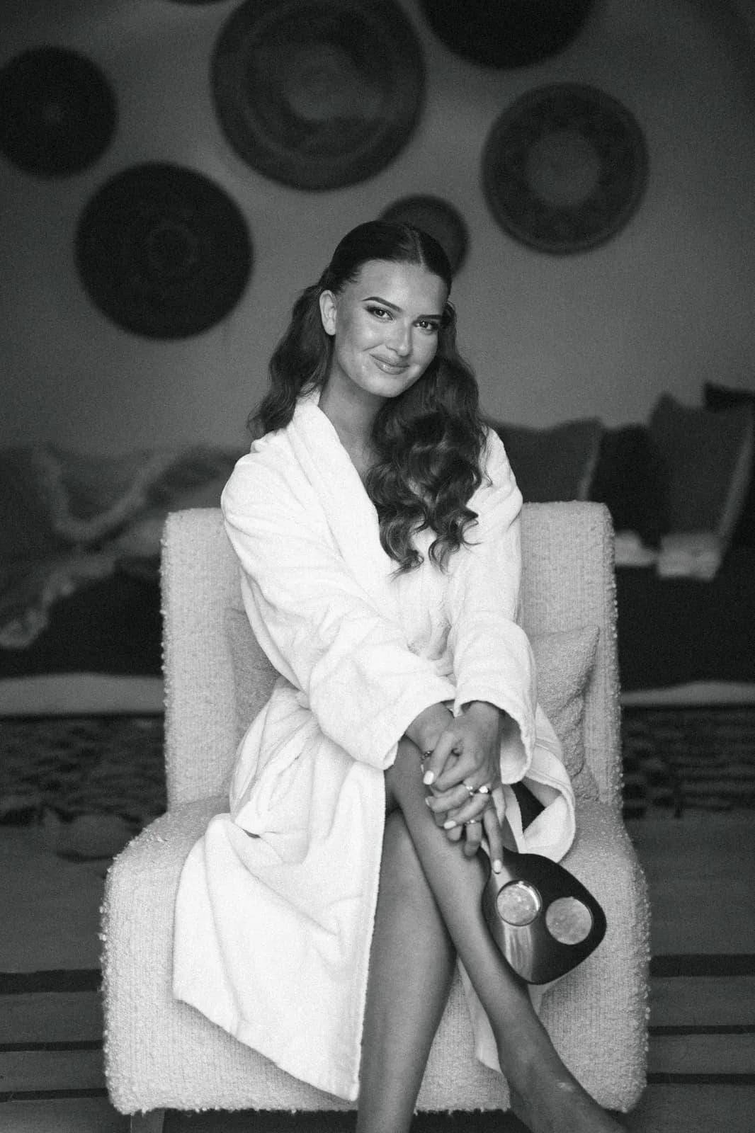 Black and white portrait of the bride relaxing in her robe before the ceremony