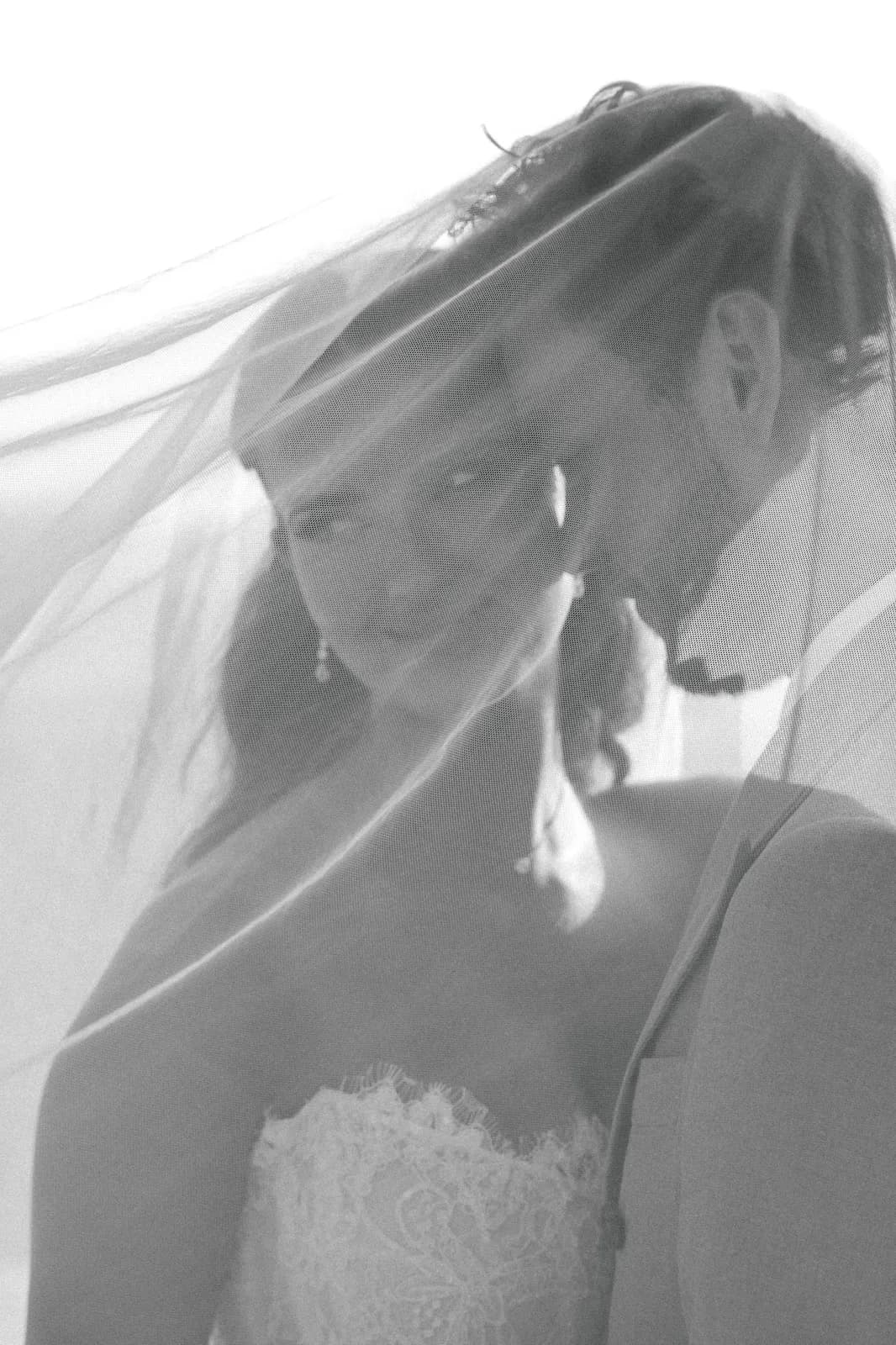 Intimate veiled portrait of the couple, soft black and white